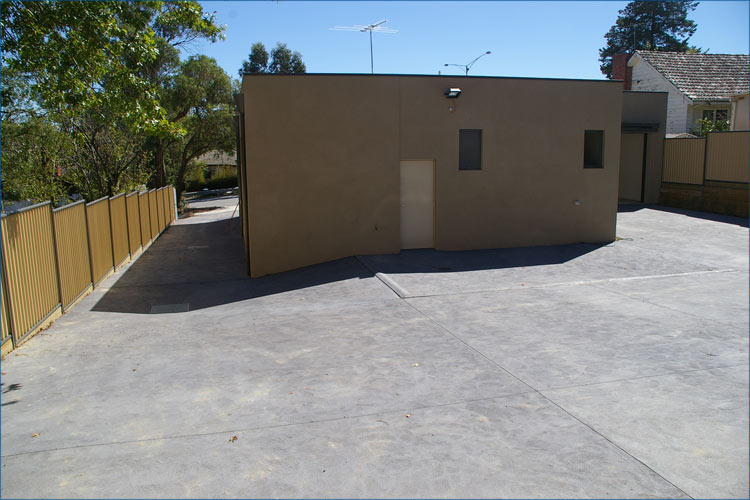 Rear parking area of the Ringwood emergency centre. This property has a slopping drainage solution in place.
