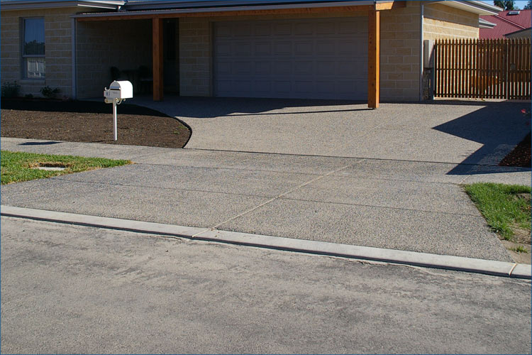 Photo of driveway concrete leading through to the rear unit property.