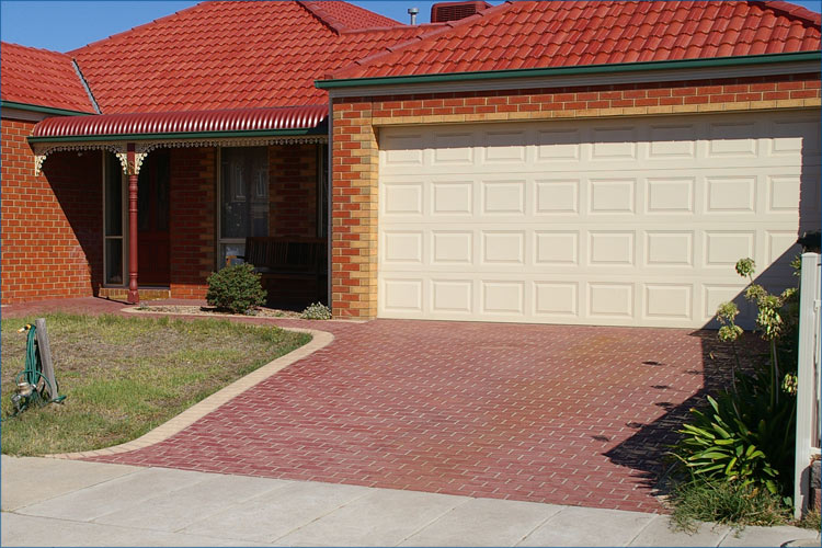 Photo of concrete stencile technique, used on coloured concrete to create a brick driveway look.